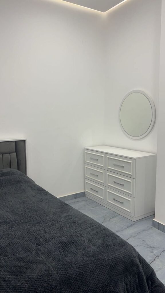 Twin bedroom with velvet bedding and blackout curtains in luxury furnished apartment near Benghazi University